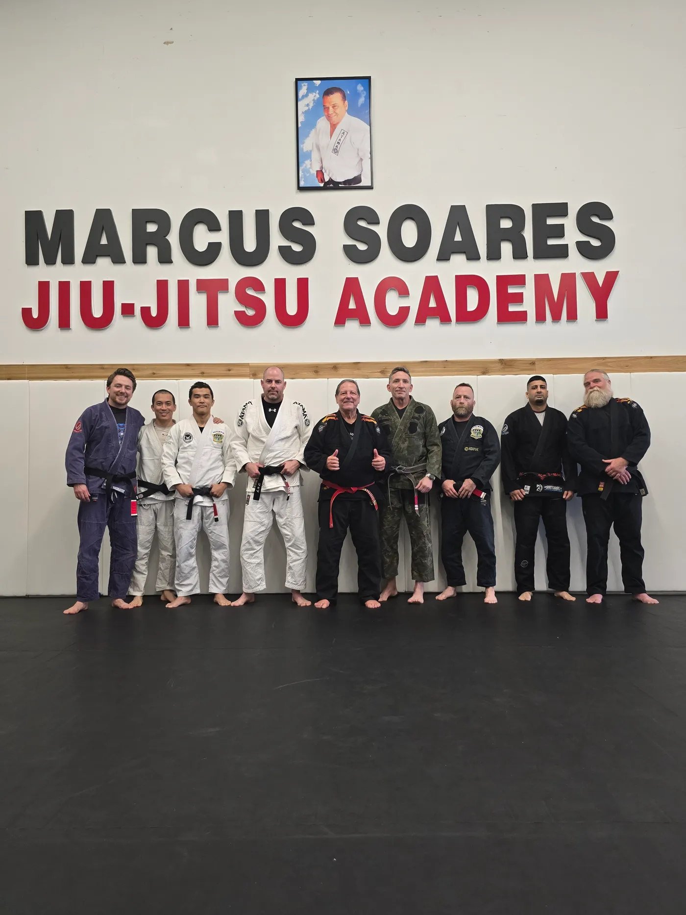 The adult class gathered under the Marcus Soares Jiu-Jitsu Academy sign in Langley