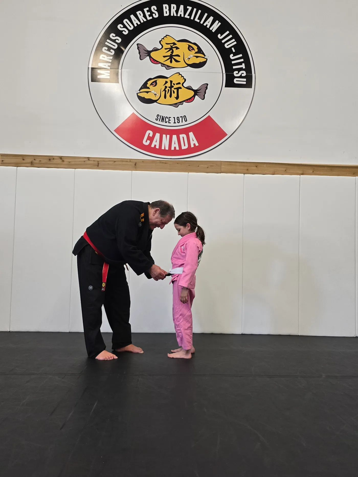 A coach working one-to-one with a young student at the Langley academy