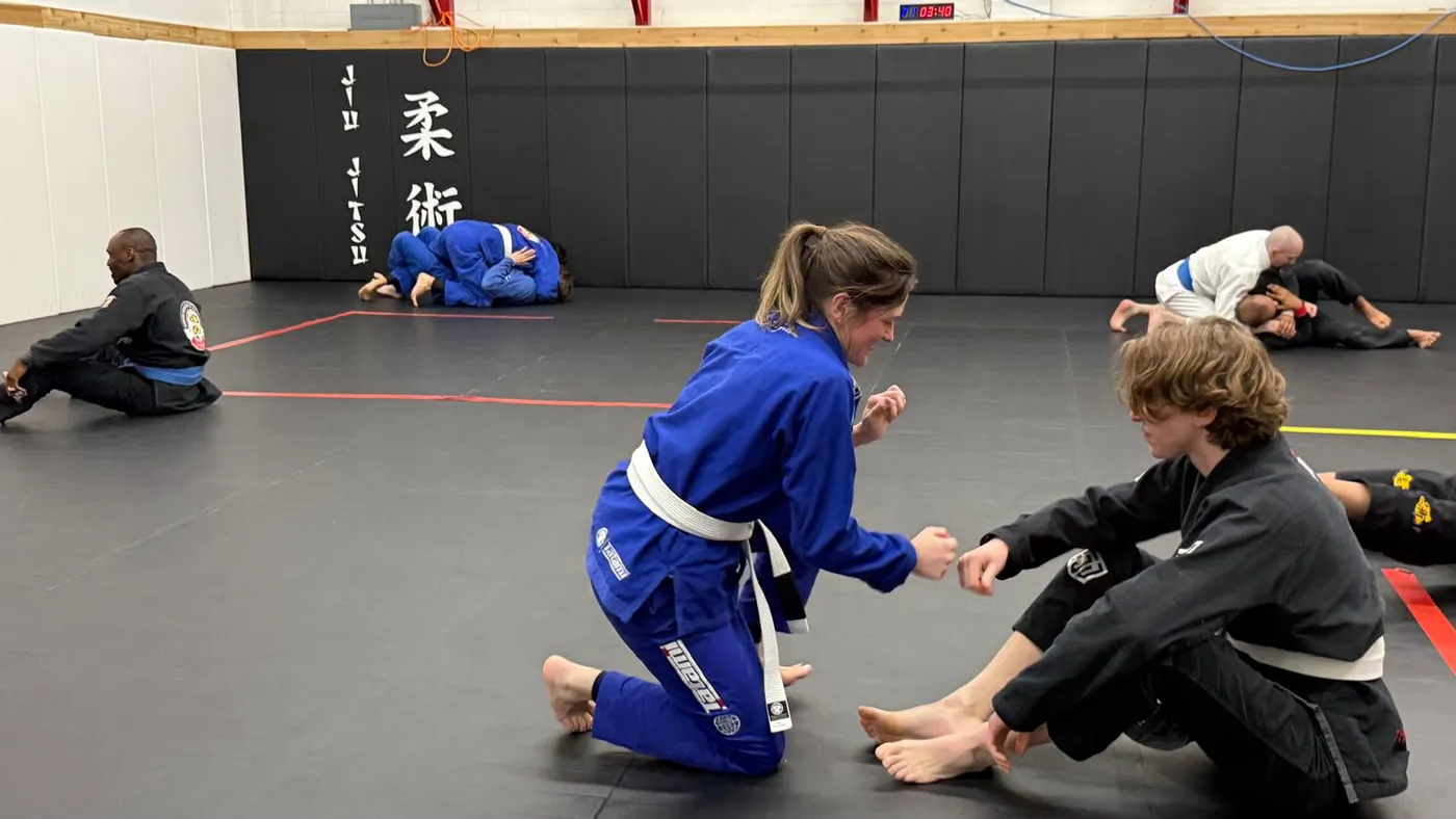 A coach walking a student through a technique at the Langley academy